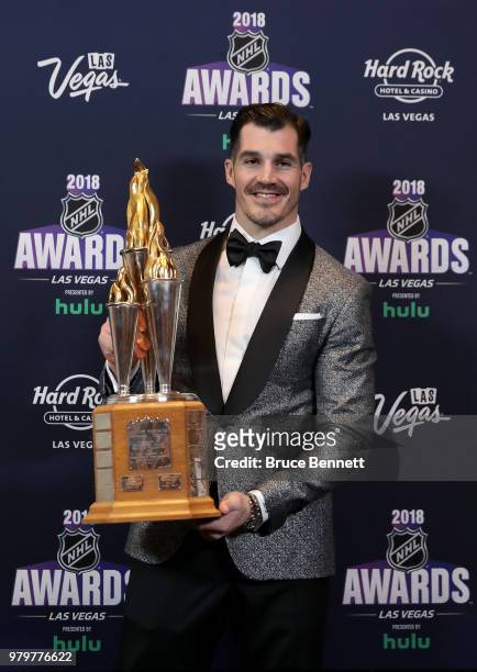 Brian Boyle of the New Jersey Devils poses with the Bill Masterton Memorial Trophy for perseverance and dedication to hockey in the press room at the...