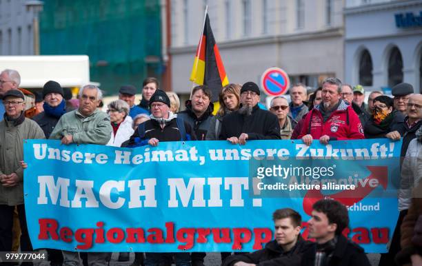 March 2018, Germany, Goerlitz: People carry a banner reading 'Unsere Heimat, unsere Zukunft! Mach mit!' at an AfD rally on labour politics in the...
