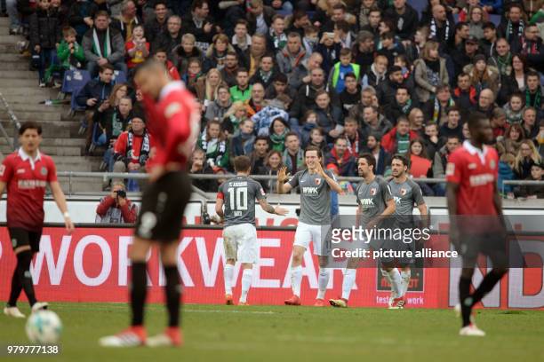 March 2018, Hanover, Germany: Bundesliga football, Hannover 96 vs FC Augsburg at the HDI-Arena. Augsburg's Michael Gregoritsch celebrates after his...