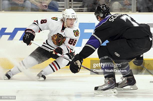 Rob Scuderi of the Los Angeles Kings defends against Patrick Kane the Chicago Blackhawks during the game on March 18, 2010 at Staples Center in Los...