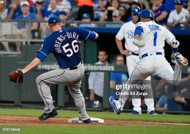 Austin Bibens-Dirkx of the Texas Rangers steps on first as he gets the force out on Ryan Goins of the Kansas City Royals in the fifth inning at...