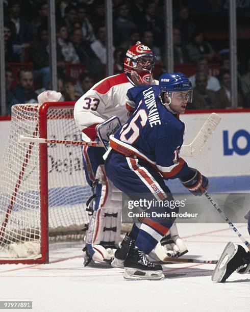 Pat LaFontaine of the New York Islanders positions himself in front of the net against goaltender Patrick Roy of the Montreal Canadiens in the 1980's...