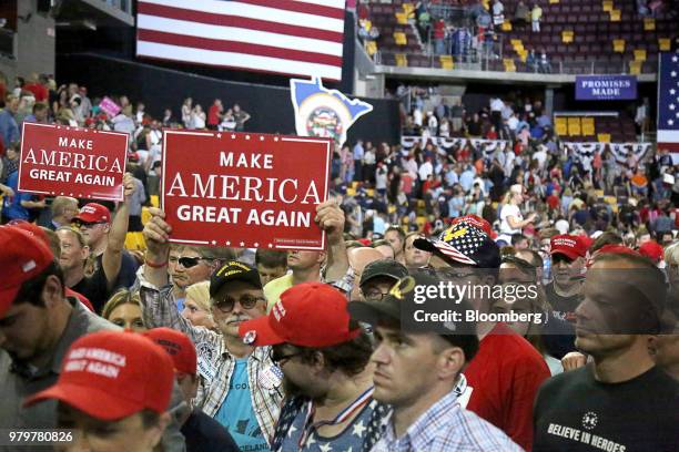 Attendees hold "Make America Great Again" signs at a rally with U.S. President Donald Trump, not pictured, in Duluth, Minnesota, U.S., on Wednesday,...