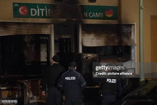 March 2018, Germany, Berlin: Police officers standing in a fire-damaged building on Kuehleweinstrasse, which houses a mosque association. A fire...