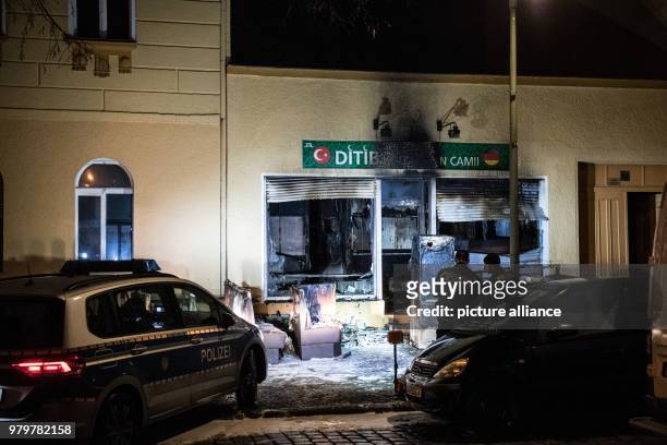 March 2018, Germany, Berlin: Police officers standing outside a fire-damaged building on Kuehleweinstrasse, which houses a mosque association. A fire...