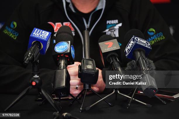 Microphones are pictured during a press conference during a Port Power AFL training session at the Adelaide Oval on June 21, 2018 in Adelaide,...