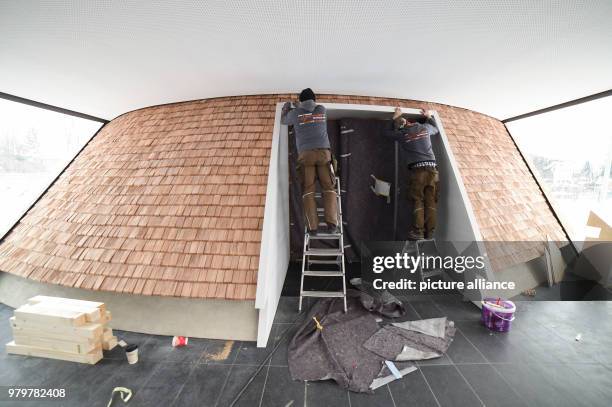 March 2018, Germany, Holzkirchen: Craftsmen put the finishing touches in the interior the new building of the Catholic Church St. Joseph. The wooden...