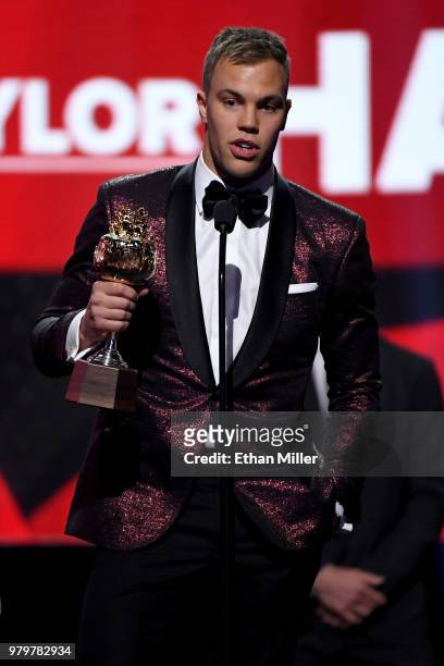 Taylor Hall of the New Jersey Devils accepts the Hart Trophy, given to the most valuable player to his team, onstage at the 2018 NHL Awards presented...