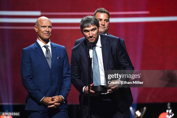 Former NHL players Mark Messier and Eric Lindros and Alex Ovechkin of the Washington Capitals present the Hart Memorial Trophy onstage at the 2018...