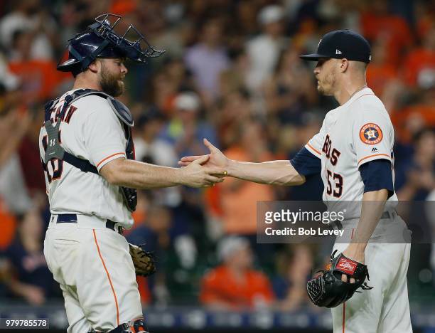 Ken Giles of the Houston Astros shakes hands with catcher Brian McCann after the final out against the Tampa Bay Rays at Minute Maid Park on June 20,...