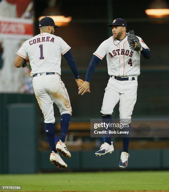 Carlos Correa of the Houston Astros and George Springer celebrate a win over the Tampa Bay Rays at Minute Maid Park on June 20, 2018 in Houston,...