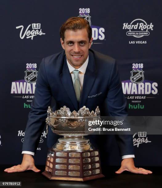 Anze Kopitar of the Los Angeles Kings poses with the Frank J. Selke trophy given to the top defensive forward in the press room at the 2018 NHL...