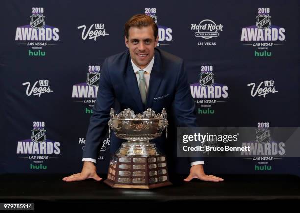 Anze Kopitar of the Los Angeles Kings poses with the Frank J. Selke trophy given to the top defensive forward in the press room at the 2018 NHL...