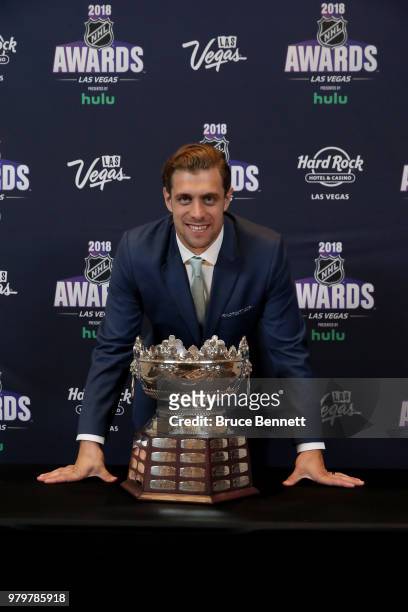 Anze Kopitar of the Los Angeles Kings poses with the Frank J. Selke trophy given to the top defensive forward in the press room at the 2018 NHL...