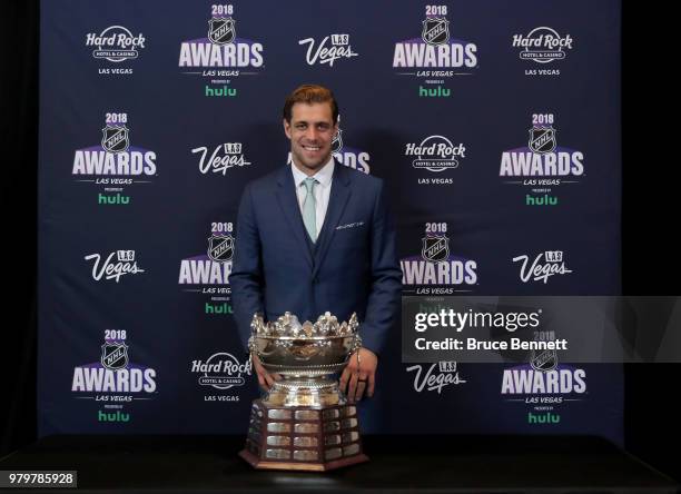 Anze Kopitar of the Los Angeles Kings poses with the Frank J. Selke trophy given to the top defensive forward in the press room at the 2018 NHL...