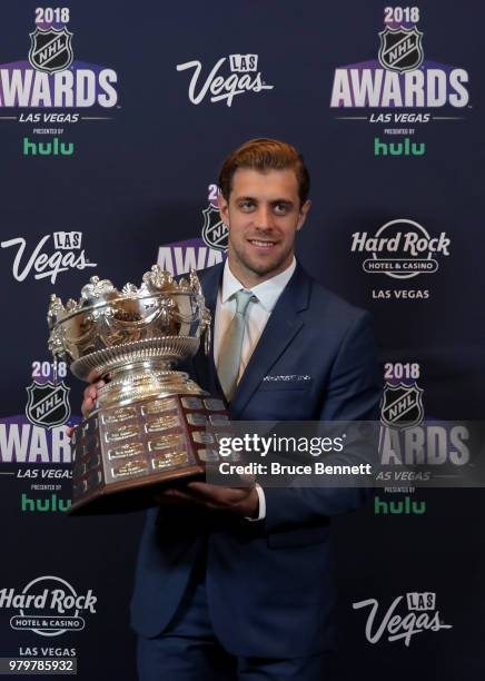 Anze Kopitar of the Los Angeles Kings poses with the Frank J. Selke trophy given to the top defensive forward in the press room at the 2018 NHL...