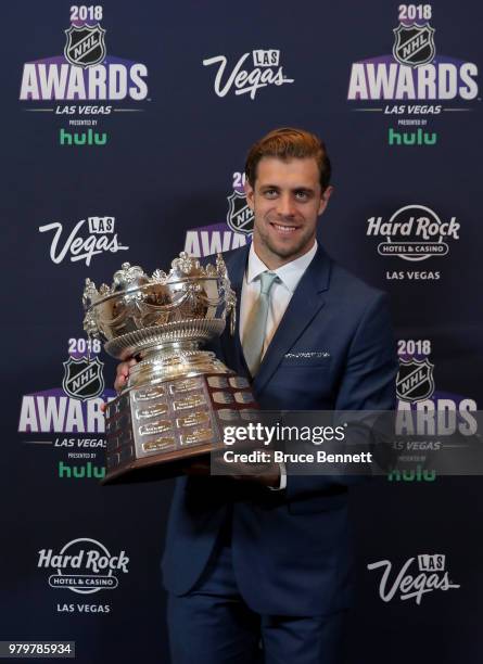 Anze Kopitar of the Los Angeles Kings poses with the Frank J. Selke trophy given to the top defensive forward in the press room at the 2018 NHL...