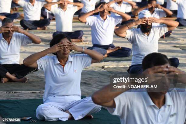 Indian Army personnel take part in a yoga session on International Yoga Day at 1 EME Centre in Secunderabad, the twin City of Hyderabad, on June 21,...