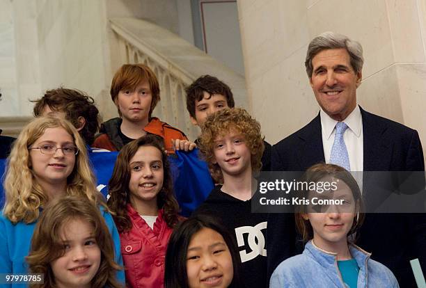 John Kerry poses for a photo during a photo op with students in the Russell Senate Office Building for the 2010 World Water Day coalition on Capitol...