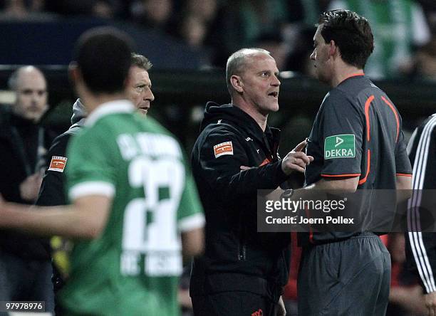 Head coach Thomas Schaaf of Bremen talks to Referee Manuel Graefe during the DFB Cup Semi Final match between SV Werder Bremen and FC Augsburg at...