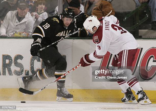 Keith Yandle of the Phoenix Coyotes handles the puck against James Neal of the Dallas Stars on March 21, 2010 at the American Airlines Center in...