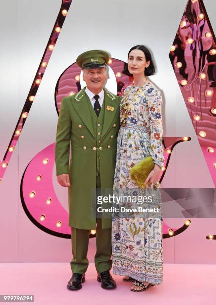 Erin O'Connor poses with the Harrods Green Man at the Summer Party at the V&A in partnership with Harrods at the Victoria and Albert Museum on June...