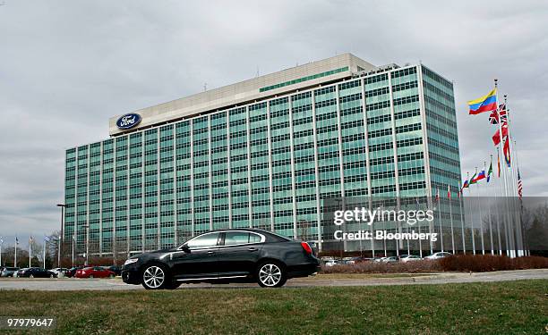 Vehicle drives outside the headquarters of Ford Motor Co. In Dearborn, Michigan, U.S., on Tuesday, March 23, 2010. In Dearborn, home of resurgent...
