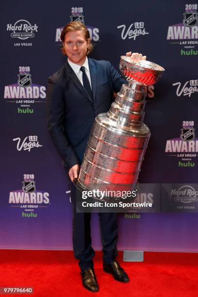 Nicklas Backstrom of the Washington Capitals poses with the Stanley Cup on the red carpet during the 2018 NHL Awards presented by Hulu at The Joint,...