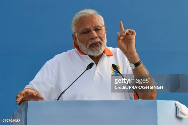 Indian Prime Minister Narendra Modi addresses participants before a mass yoga session along with other practitioners to mark International Yoga Day...