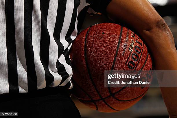 An official holds the ball during the game between the Ohio State Buckeyes against the Michigan Wolverines in the quarterfinals of the Big Ten Men's...