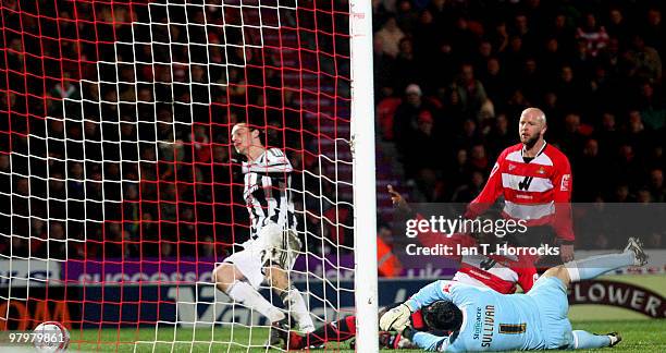 Andy Carroll of Newcastle scores the opening goal during the Coca Cola Championship match between Doncaster Rovers and Newcastle United at The...