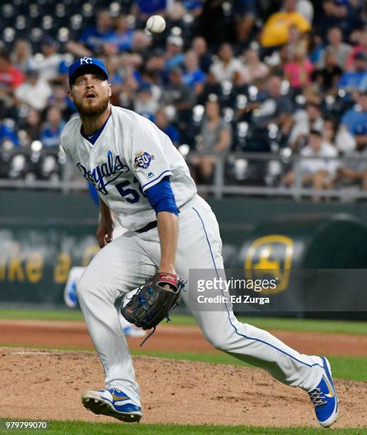 Justin Grimm of the Kansas City Royals chases down a ball hit by Jurickson Profar of the Texas Rangers in the eighth inning at Kauffman Stadium on...