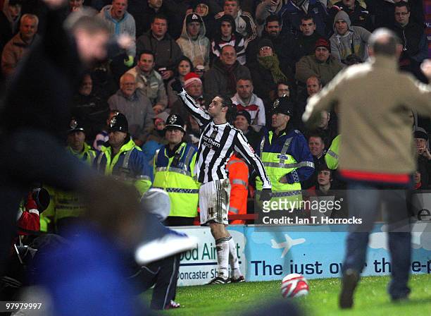 Andy Carroll of Newcastle celebrates scoring the first goal as fans invade the pitch, during the Coca Cola Championship match between Doncaster...