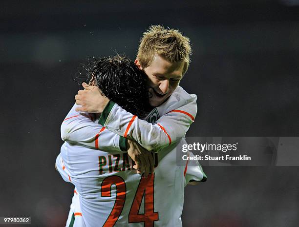 Claudio Pizarro of Bremen celebrates scoring his team's second goal with Marko Marin, scorer of the first goal during the DFB cup semi final match...