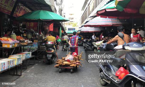 This photo taken on June 20, 2018 shows a vendor pulling a trolley with dog meat piled on top at the Dongkou market in Yulin in China's southern...