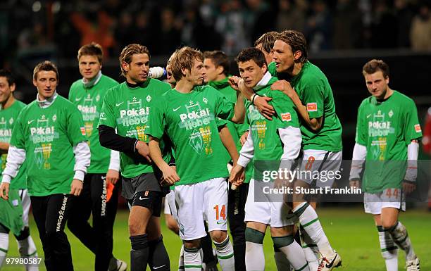 Aaron Hunt, Tim Wiese, Sebastian Boenisch and Clemens Fritz of Bremen celebrate at the end of the DFB cup semi final match between SV Werder Bremen...