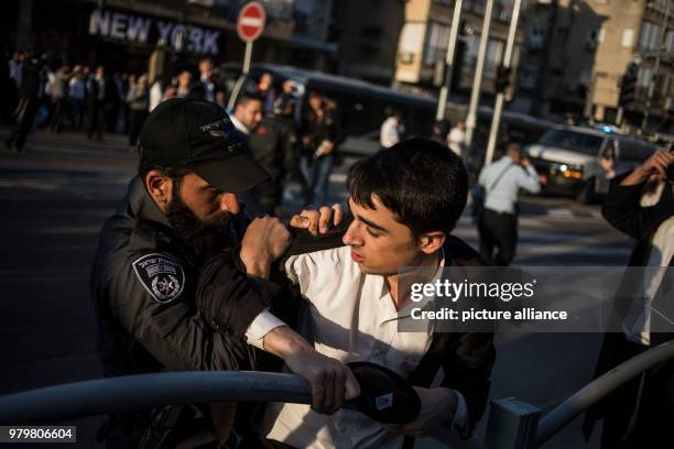 Dpatop - An Israeli serviceman arrests an Ultra-Orthodox Jewish man during a demonstration against Israeli army conscription in Bnei Brak, Israel, 12...