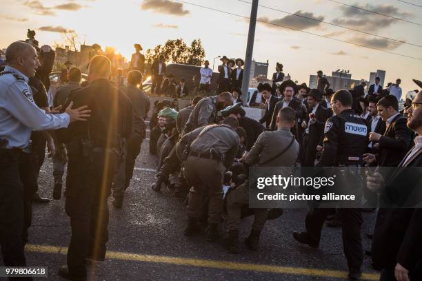 Dpatop - Israeli policemen attempt to disperse Ultra-Orthodox Jewish men during a demonstration against Israeli army conscription in Bnei Brak,...