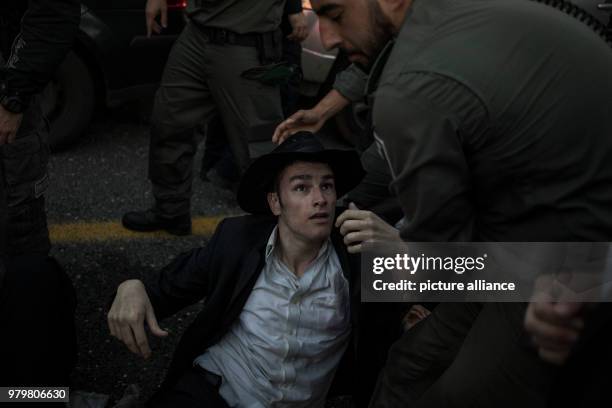 Dpatop - An Ultra-Orthodox Jewish protester skirmishes with policemen during a demonstration against Israeli army conscription in Bnei Brak, Israel,...