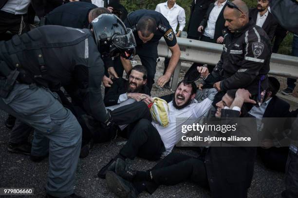 Israeli policemen attempt to disperse Ultra-Orthodox Jewish protesters during a demonstration against Israeli army conscription in Bnei Brak, Israel,...