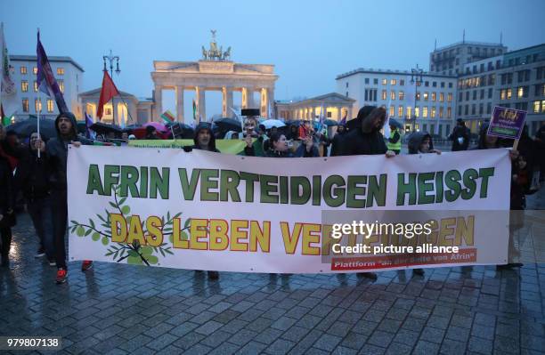 March 2018, Germany, Berlin: Some two hundred Kurs protest with a banner reading 'Afrin verteidigen heisst das Leben verteidigen' against the Turkish...