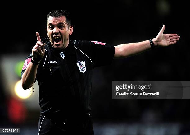 Phil Dowd, the match referee, gestures during the Barclays Premier League match between West Ham United and Wolverhampton Wanderers at the Boleyn...