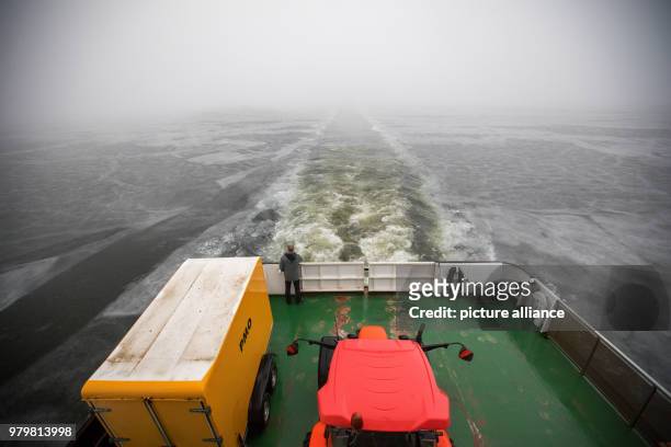 March 2018, Germany, Schaprode: The ferry "Vitte" crossing to the island of Hiddensee across a still thick layer of ice on the Baltic Sea. Photo:...
