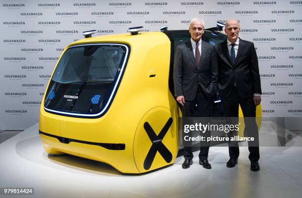 March 2018, Berlin: Matthias Mueller , chairman of the board of Volkswagen AG, and CFO Frank Witter standing before the self-driving Sedric Schoolbus...