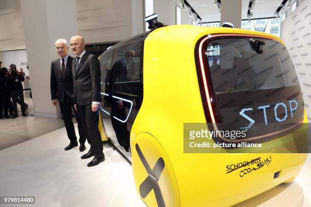 March 2018, Berlin: Matthias Mueller , chairman of the board of Volkswagen AG, and CFO Frank Witter standing before the self-driving Sedric Schoolbus...