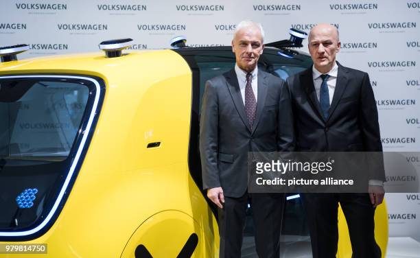 March 2018, Matthias Mueller , chairman of the board of Volkswagen AG, and CFO Frank Witter standing before the self-driving Sedric Schoolbus during...
