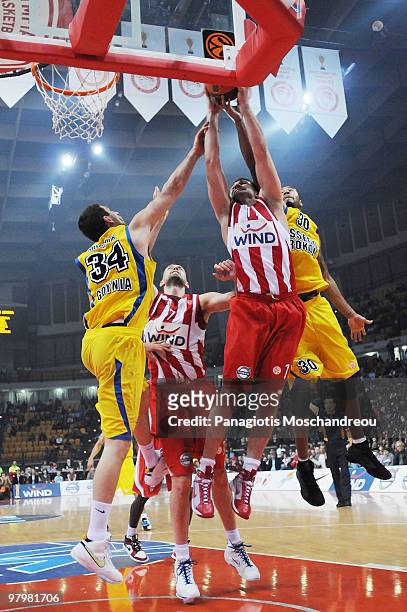 Ronnie Burrell, #30 of Asseco Prokom Gdynia competes with Linas Kleiza, #11 of Olympiacos Piraeus during the Euroleague Basketball 2009-2010 Play Off...