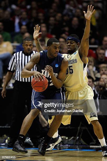 Jamel McLean of the Xavier Musketeers posts up Nasir Robinson of the Pittsburgh Panthers during the second round of the 2010 NCAA men's basketball...