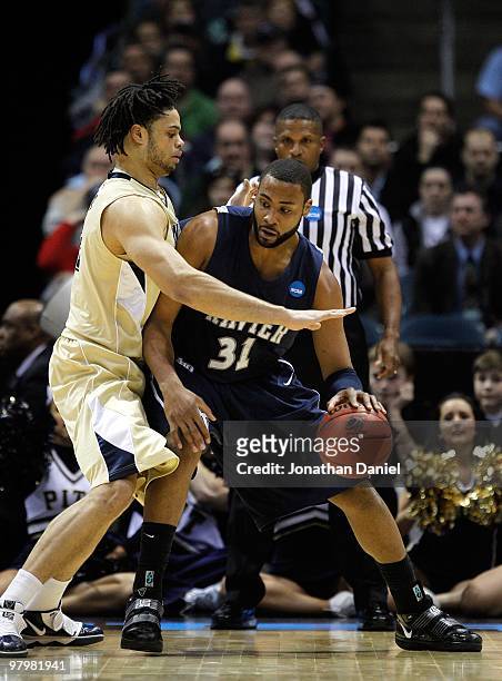 Jason Love of the Xavier Musketeers posts up Gary McGhee of the Pittsburgh Panthers during the second round of the 2010 NCAA men's basketball...