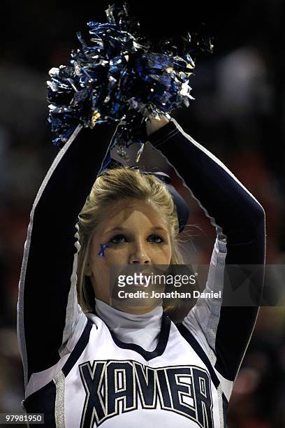 An Xavier Musketeers cheerleader performs during a break in the game against the Pittsburgh Panthers during the second round of the 2010 NCAA men's...